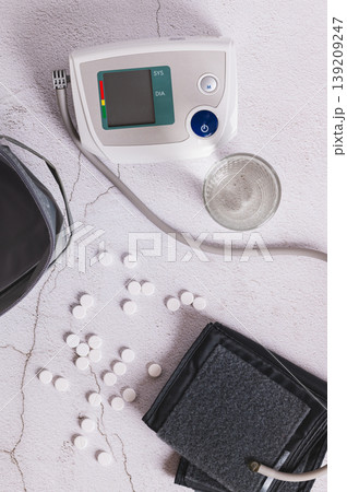 Blood pressure measurement, medications and water on the table top and vertical view 139209247