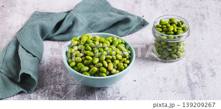 Frozen green peeled edamame beans in a bowl on a table web banner Frozen green peeled edamame beans in a bowl on a table web banner 139209267