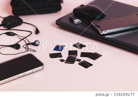 Flash drives, smartphones, a laptop, headphones, and a hard drive on the table Flash drives, smartphones, a laptop, headphones, and a hard drive on the table 139209277