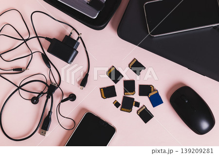 Flash drives, smartphones, a laptop, headphones, and a hard drive on the table top view Flash drives, smartphones, a laptop, headphones, and a hard drive on the table top view 139209281