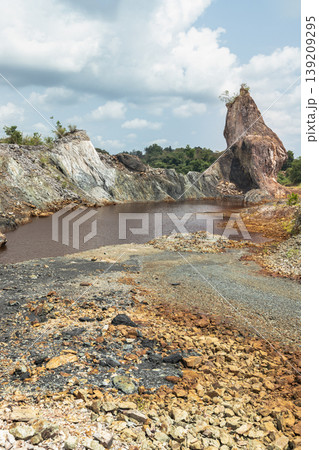 The Grand Canyon Chanthaburi or the Nong Bua Old Stone Mine is a landscape of striking elemental friction. Beneath a soft canopy of cumulus clouds, excavated earth rises in a rugged palette of The Grand Canyon Chanthaburi or the Nong Bua Old Stone Mine is a landscape of striking elemental friction. Beneath a soft canopy of cumulus clouds, excavated earth rises in a rugged palette of 139209295