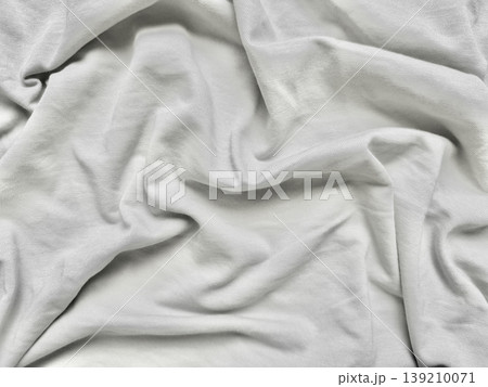 elegant wrinkled silver gray fabric draping softly over serene blue surface perfect for abstract wallpaper or subtle banner background 139210071