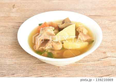 boiled pineapple with pork bone and carrot couple pickled radish topping black mushroom soup on bowl boiled pineapple with pork bone and carrot couple pickled radish topping black mushroom soup on bowl 139210869