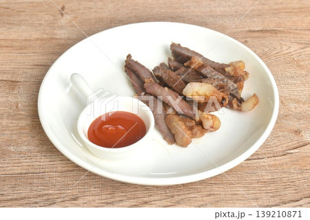 fried crispy salty fermenting beef fat meat with pepper on plate dipping spicy chili sauce fried crispy salty fermenting beef fat meat with pepper on plate dipping spicy chili sauce 139210871