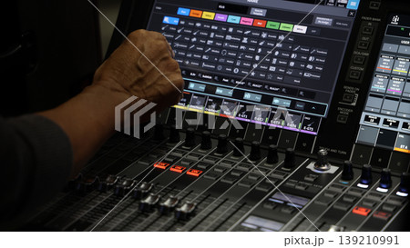 Mixing operation. Professional audio or sound engineers operating digital mixing consoles in studio or live mix perform. Sound control music production broadcasting mix and live event audio technology Mixing operation. Professional audio or sound engineers operating digital mixing consoles in studio or live mix perform. Sound control music production broadcasting mix and live event audio technology 139210991