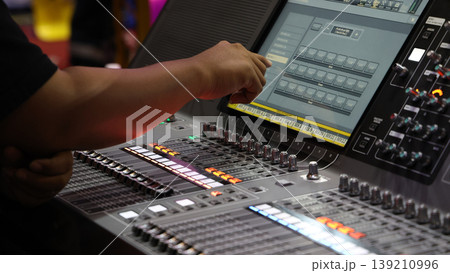 Mixing operation. Professional audio or sound engineers operating digital mixing consoles in studio or live mix perform. Sound control music production broadcasting mix and live event audio technology Mixing operation. Professional audio or sound engineers operating digital mixing consoles in studio or live mix perform. Sound control music production broadcasting mix and live event audio technology 139210996