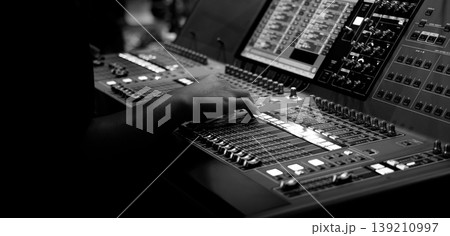 Mixing operation. Professional audio or sound engineers operating digital mixing consoles in studio or live mix perform. Sound control music production broadcasting mix and live event audio technology Mixing operation. Professional audio or sound engineers operating digital mixing consoles in studio or live mix perform. Sound control music production broadcasting mix and live event audio technology 139210997