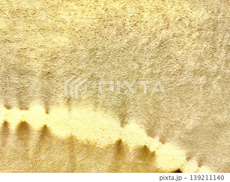 shimmering gold vinyl texture melting into soft wavy patterns on luxurious foil surface with blank copy space for premium wallpapers and elegant banners 139211140
