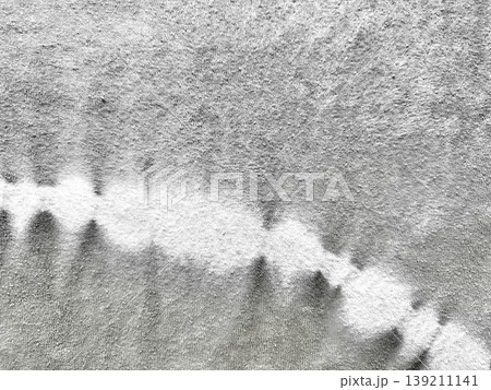 wavy white powder trail on gritty gray concrete surface closeup abstract texture for wallpaper or banner with copy space 139211141