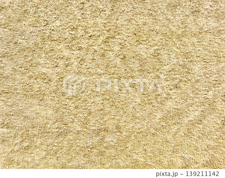 soft golden terrycloth texture closeup showcasing looped fibers and warm hues for luxury spa background or serene wallpaper 139211142