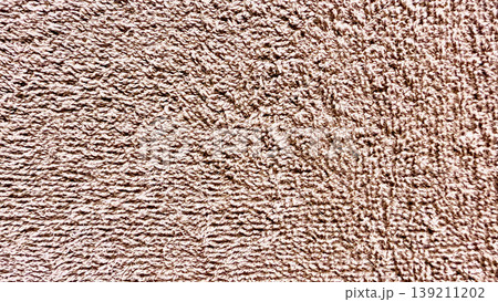 closeup of soft brown terry cloth texture with looped fibers evoking cozy warmth ideal for spa banner or bathroom wallpaper closeup of soft brown terry cloth texture with looped fibers evoking cozy warmth ideal for spa banner or bathroom wallpaper 139211202