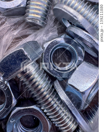 Different types of nuts and bolts arranged in a pile for hardware use Different types of nuts and bolts arranged in a pile for hardware use 139211880