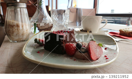 Chocolate Cake Dessert with Fresh Berries and Powdered Sugar Chocolate Cake Dessert with Fresh Berries and Powdered Sugar 139211952