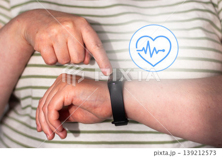 Woman checks health indicators using tracking app on smartwatch. Smart health means using devices as assistants not overlords. Low alarm high-awareness living. Digital detox concept Woman checks health indicators using tracking app on smartwatch. Smart health means using devices as assistants not overlords. Low alarm high-awareness living. Digital detox concept 139212573