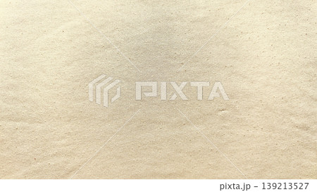 soft beige linen fabric closeup revealing intricate woven threads and subtle grainy texture radiating warm earthy elegance 139213527