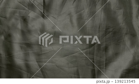 crumpled gray fabric texture closeup with intricate ribbed patterns shadowy folds and enigmatic depth in abstract minimalist composition crumpled gray fabric texture closeup with intricate ribbed patterns shadowy folds and enigmatic depth in abstract minimalist composition 139213545