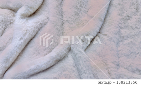 soft fluffy pastel faux fur texture twisting elegantly in macro closeup evoking luxurious coziness and serene winter elegance soft fluffy pastel faux fur texture twisting elegantly in macro closeup evoking luxurious coziness and serene winter elegance 139213550