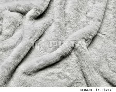 luxurious white faux fur closeup texture with soft wavy folds and silky strands evoking cozy winter warmth 139213551