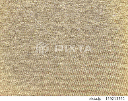 luxurious shimmering golden knit fabric texture closeup with warm beige hues and metallic threads evoking elegance and coziness 139213562