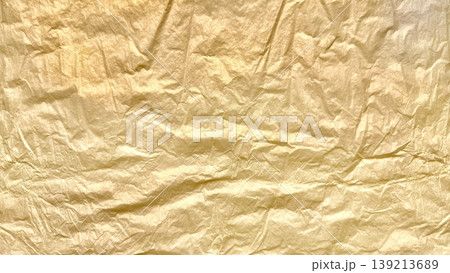 crinkled golden foil texture gleaming with subtle sheen abstract luxury background evoking opulence and vintage elegance 139213689