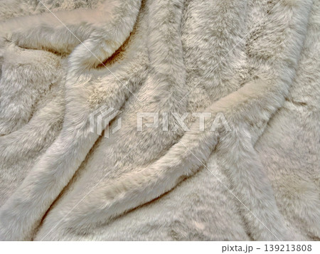 creamy white fur texture draped elegantly in soft waves macro closeup luxurious fabric folds 139213808