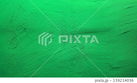 vibrant emerald green smeared plaster texture with subtle brush strokes evoking fresh eco energy in abstract wall backdrop 139214036