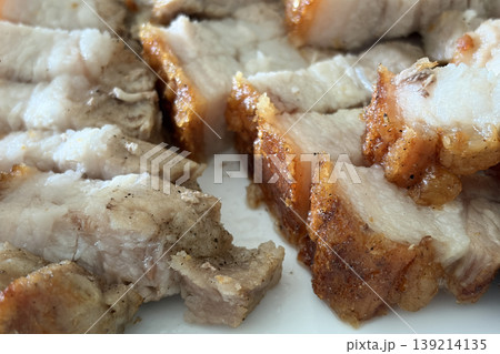 Bite sized roasted pork belly pieces arranged tightly representing crunchy crackling and delicious cooked food background. 139214135