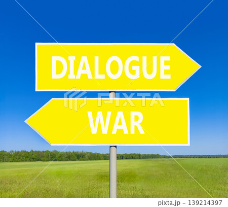 Dialogue instead war symbol. Concept words Dialogue and War on beautiful yellow road sign. Beautiful blue sky green grass background. Social and dialogue instead war concept. Copy space. 139214397
