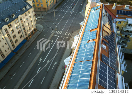 Top view of blue solar photo voltaic panels system on high apartment building roof top on sunny day. Renewable ecological green energy production concept. 139214812