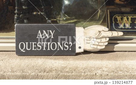 Any questions symbol. Concept words Any questions on beautiful wooden black sign as a hand. Beautiful store display background. Business and Any questions Q and A concept, copy space. 139214877