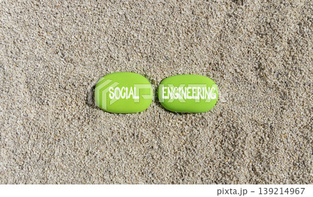 Social engineering words symbol. Concept words Social engineering on beautiful green stones. Beautiful sand background. Business and Social engineering words concept. Copy space. 139214967