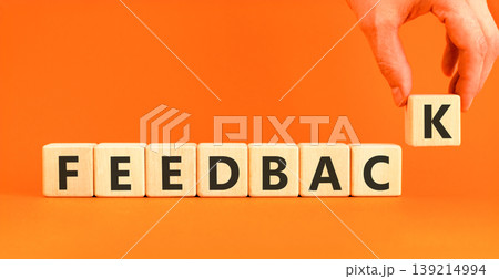 Feedback word symbol. Concept word Feedback on beautiful wooden blocks. Beautiful orange background. Businessman's hand. Business support help feedback word concept. Copy space. 139214994