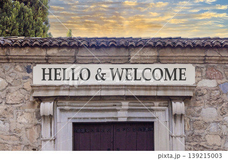 Hello and welcome symbol. Concept words Hello and welcome on beautiful big marble white sign plate. Beautiful old stone wall background. Business hello and welcome concept. Copy space. Hello and welcome symbol. Concept words Hello and welcome on beautiful big marble white sign plate. Beautiful old stone wall background. Business hello and welcome concept. Copy space. 139215003