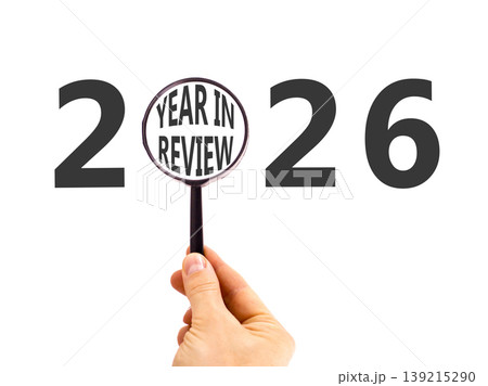 2026 year in review symbol. Concept words 2026 year in review in beautiful magnifying glass. Beautiful white background. Businessman's hand. Business 2026 year in review concept. Copy space. 139215290