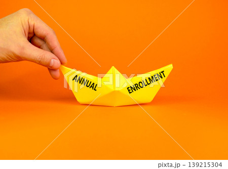 Annual enrollment words symbol. Concept words Annual enrollment on beautiful yellow paper boat. Beautiful orange background. Doctor hand. Medical and Annual enrollment words concept. Copy space. Annual enrollment words symbol. Concept words Annual enrollment on beautiful yellow paper boat. Beautiful orange background. Doctor hand. Medical and Annual enrollment words concept. Copy space. 139215304