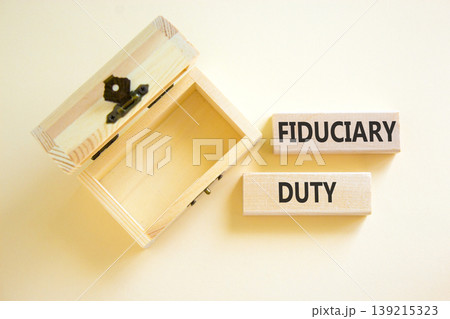 Fiduciary duty words symbol. Concept words Fiduciary duty on beautiful wooden blocks. Beautiful white background. Empty wooden chest. Business and Fiduciary duty words concept. Copy space. 139215323