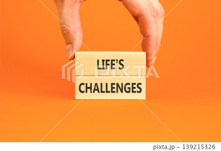 Life's challenges words symbol. Concept words Life's challenges on beautiful wooden blocks. Beautiful orange background. Businessman hand. Business lifestyle Life's challenges words concept Copy space Life's challenges words symbol. Concept words Life's challenges on beautiful wooden blocks. Beautiful orange background. Businessman hand. Business lifestyle Life's challenges words concept Copy space 139215326
