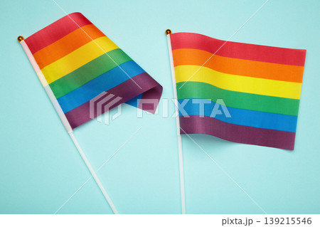 LGBT rainbow flag flat lay on blue background. Space for text LGBT rainbow flag flat lay on blue background. Space for text 139215546