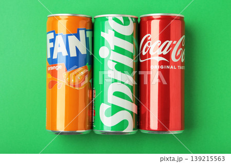 Mykolaiv, Ukraine - March 25, 2026: Iron cans of Coca Cola, Fanta and Sprite drink on green background. Mykolaiv, Ukraine - March 25, 2026: Iron cans of Coca Cola, Fanta and Sprite drink on green background. 139215563