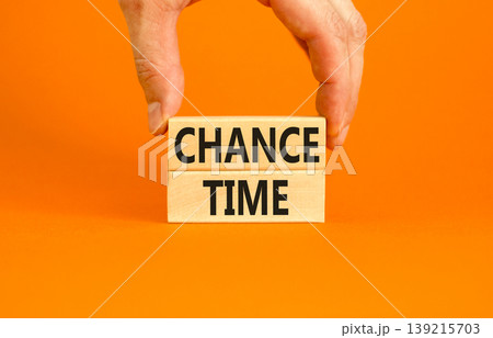 Chance time symbol. Concept word Chance time on beautiful wooden blocks. Beautiful orange paper background. Businessman's hand. Business chance time concept. Copy space. Chance time symbol. Concept word Chance time on beautiful wooden blocks. Beautiful orange paper background. Businessman's hand. Business chance time concept. Copy space. 139215703