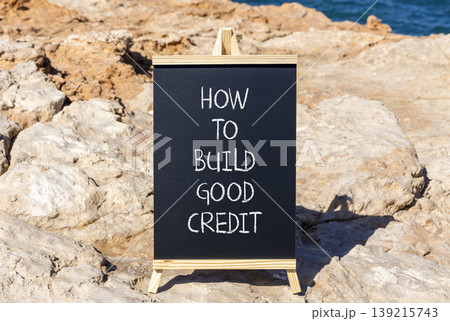 How to build good credit symbol. Concept words How to build good credit on beautiful black blackboard. Beautiful stone and blue sea background. Business how to build good credit concept. Copy space. How to build good credit symbol. Concept words How to build good credit on beautiful black blackboard. Beautiful stone and blue sea background. Business how to build good credit concept. Copy space. 139215743