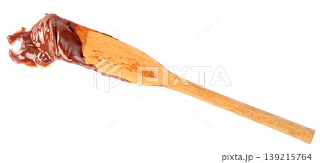 Wooden spatula with a thick smear of dark chocolate cream or hazelnut spread isolated. Professional tool for baking, dessert preparation, and sweet food concept imagery. Wooden spatula with a thick smear of dark chocolate cream or hazelnut spread isolated. Professional tool for baking, dessert preparation, and sweet food concept imagery. 139215764
