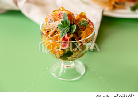 layered coffee fruit jelly dessert in glass bowl on green background layered coffee fruit jelly dessert in glass bowl on green background 139215937