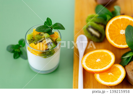 fresh yogurt with kiwi and orange slices in glass cup fresh yogurt with kiwi and orange slices in glass cup 139215958