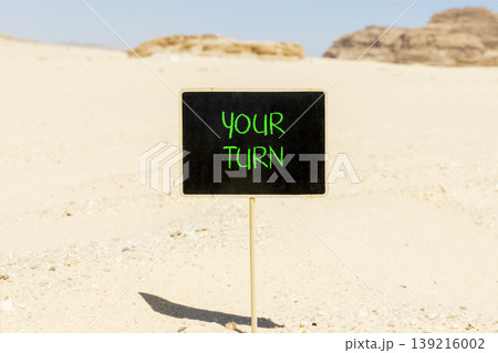 Your turn words symbol. Concept words Your turn on beautiful blackboard. Beautiful Sinai desert sand background. Business your turn motivational support concept. Copy space. Your turn words symbol. Concept words Your turn on beautiful blackboard. Beautiful Sinai desert sand background. Business your turn motivational support concept. Copy space. 139216002