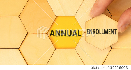 Annual enrollment words symbol. Concept words Annual enrollment on beautiful wooden puzzles. Beautiful yellow background. Doctor hand. Medical and Annual enrollment words concept. Copy space. 139216008