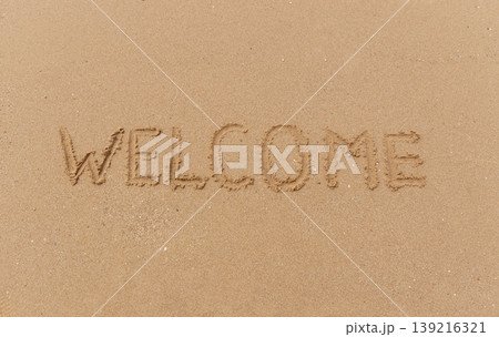 Business hello and welcome concept. Concept word Welcome written on beautiful ocean sea sand beach. Beautiful ocean sand beach background, copy space. Business hello and welcome concept. 139216321