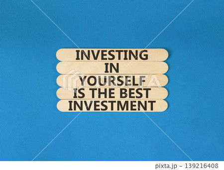 Investing in yourself symbol. Concept words Investing in yourself is the best investment on beautiful wooden sticks. Beautiful blue background. Business investing in yourself concept. Copy space Investing in yourself symbol. Concept words Investing in yourself is the best investment on beautiful wooden sticks. Beautiful blue background. Business investing in yourself concept. Copy space 139216408