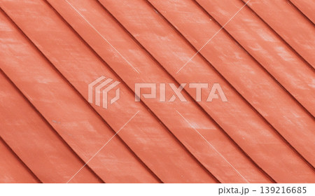 Metal roof painted in red. Warm, rustic texture with diagonal lines 139216685
