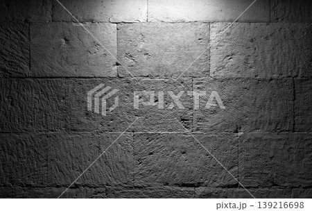 A close-up view of a rough gray stone wall with spot light A close-up view of a rough gray stone wall with spot light 139216698